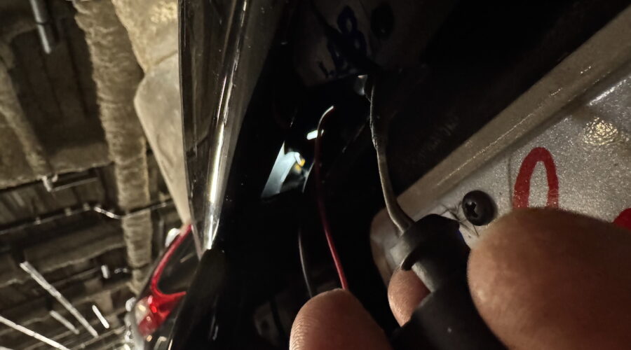 View through license light hole to the lit tail light hole.