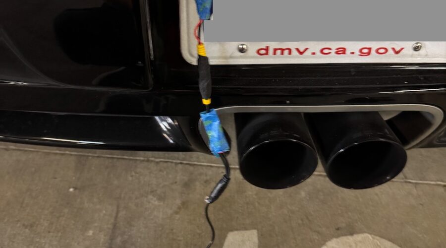 Rear camera wiring dangling from plate light hole.