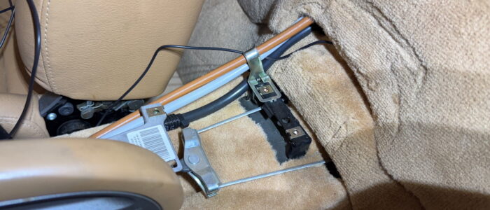 Follow the shifter cables through the center console.