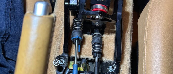 You should be able to send the RCA cable down under the shift assembly with the other wiring, through to the back of the dash console. You can see the RCA wire exiting at the upper left.
